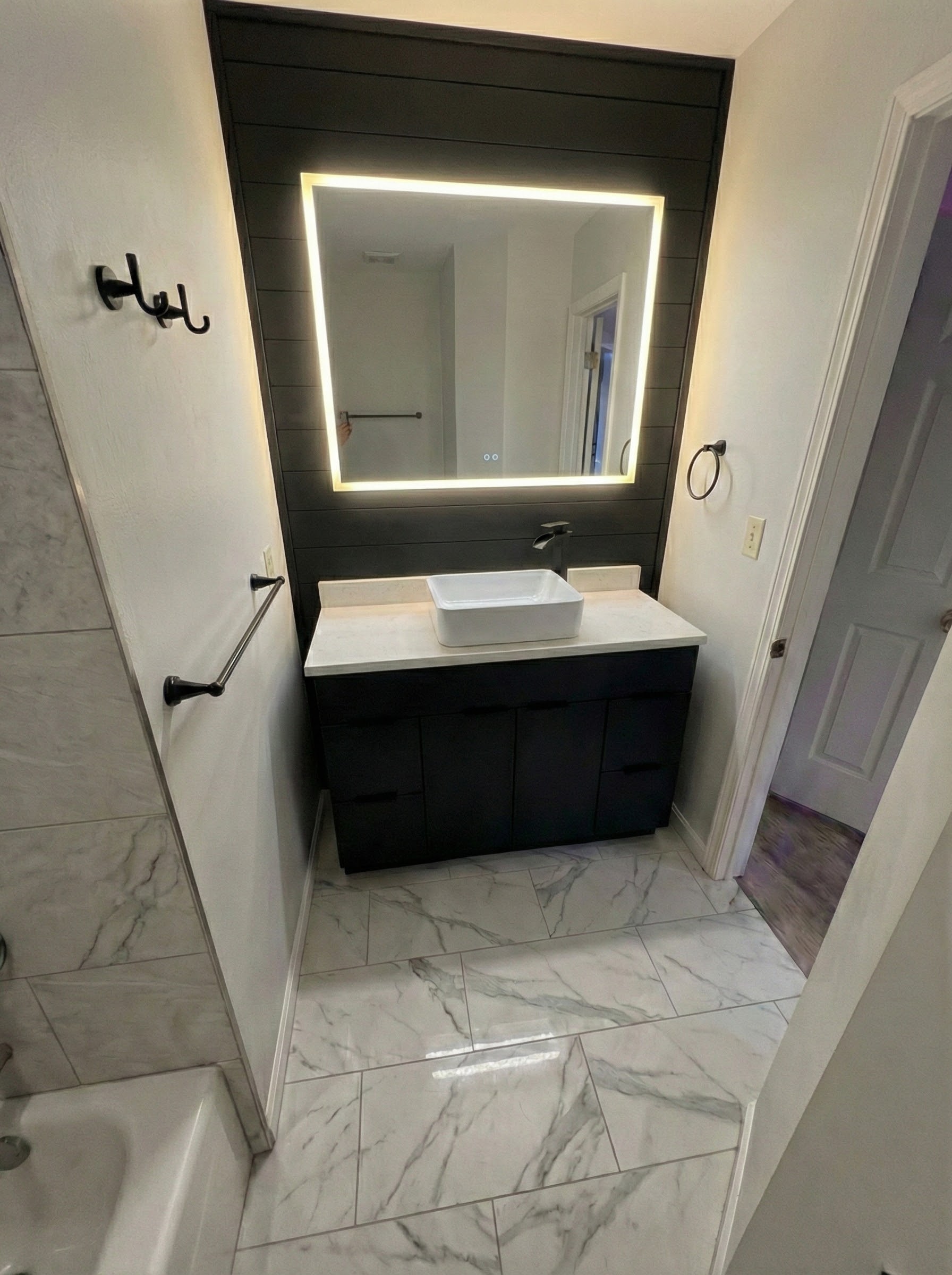 Bathroom after renovation with a freestanding tub and tiled shower