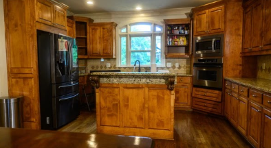 Original stained-wood kitchen cabinetry before refinishing