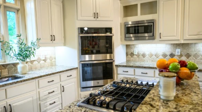 Gas cooktop island with granite top and refinished perimeter cabinets