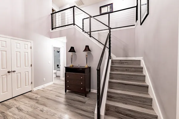 Completed staircase with black metal railing and gray stair treads